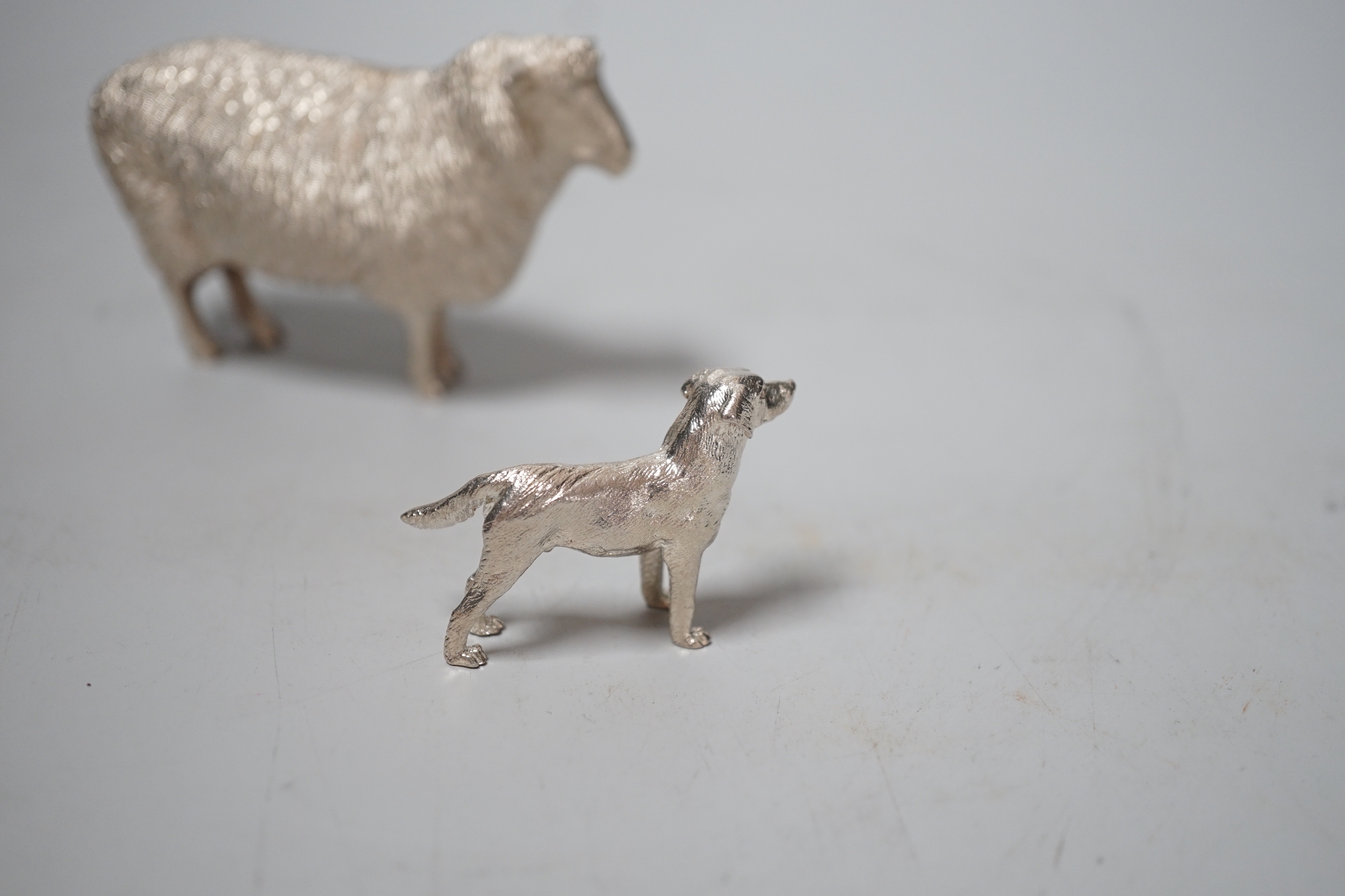 An Elizabeth II silver free-standing model of a sheep, Edward Barnard & Sons Ltd, London, 1993, length 95mm and a smaller silver model free-standing dog, 8.6oz.